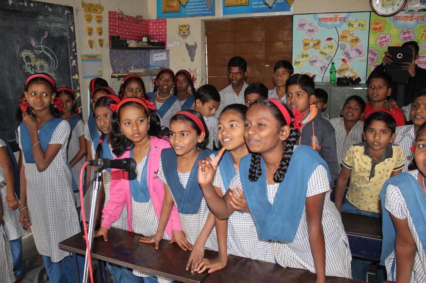Volunteers engaging with rural schoolgirls in a classroom
