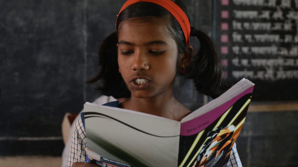 A rural schoolgirl reading a book